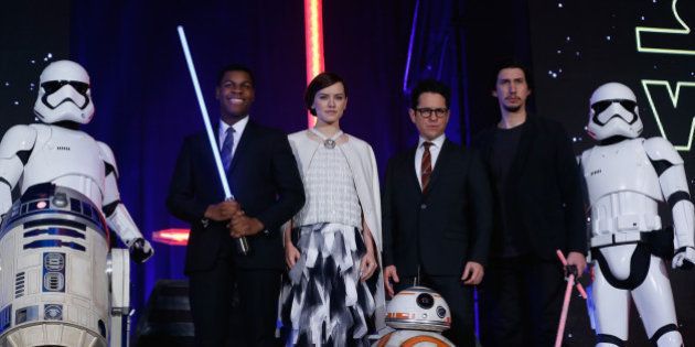 TOKYO, JAPAN - DECEMBER 10: (from left) Stormtrooper, R2-D2, John Boyega, Daisy Ridley, J.J. Abrams, BB-8, Adam Driver and Stormtrooper attend the 'Star Wars: The Force Awakens' fan event at the Roppongi Hills on December 10, 2015 in Tokyo, Japan. (Photo by Christopher Jue/Getty Images for Walt Disney Studios)