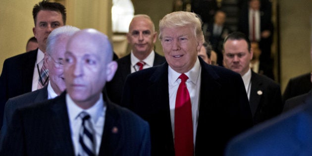 U.S. President Donald Trump, center, walks to a House Republican conference meeting at the U.S. Capitol in Washington, D.C., U.S., on Tuesday, March 21, 2017. Trump warned House Republicans in a closed-door meeting Tuesday that many of them could lose their seats in the 2018 elections if they don't pass their bill to replace Obamacare. Photographer: Andrew Harrer/Bloomberg via Getty Images