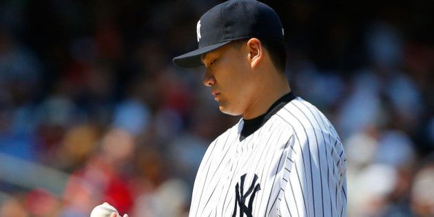NEW YORK, NY - JUNE 22: Masahiro Tanaka #19 of the New York Yankees looks at the ball after surrendering a run in the seventh inning against the Baltimore Orioles at Yankee Stadium on June 22, 2014 in the Bronx borough of New York City. (Photo by Jim McIsaac/Getty Images)