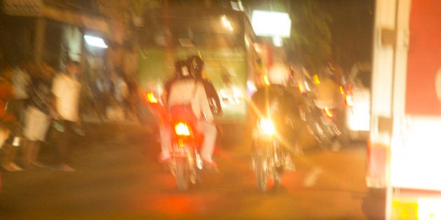 Blurred night traffic scene on the island of Bali in Indonesia. Buses and motorcycles make up a large percentage of those using the road.