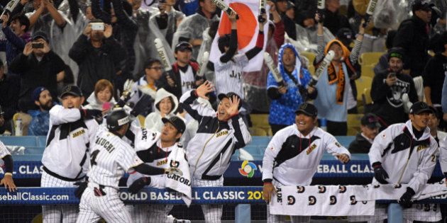 LOS ANGELES, CA - MARCH 21: Ryosuke Kikuchi #4 of of Team Japan celebrates with teammates after hitting a solo home run in the sixth inning of Game 2 of the Championship Round of the 2017 World Baseball Classic against Team USA on Tuesday, March 21, 2017 at Dodger Stadium in Los Angeles, California. (Photo by Matt Brown/WBCI/MLB Photos via Getty Images)