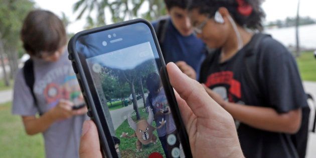 Pinsir, a Pokemon, is found by a group of Pokemon Go players, Tuesday, July 12, 2016, at Bayfront Park in downtown Miami. The