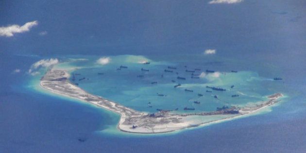Chinese dredging vessels are purportedly seen in the waters around Mischief Reef in the disputed Spratly Islands in the South China Sea in this still image from video taken by a P-8A Poseidon surveillance aircraft provided by the United States Navy May 21, 2015. U.S. Navy/Handout via Reuters/File Photo ATTENTION EDITORS - THIS PICTURE WAS PROVIDED BY A THIRD PARTY. REUTERS IS UNABLE TO INDEPENDENTLY VERIFY THE AUTHENTICITY, CONTENT, LOCATION OR DATE OF THIS IMAGE. THIS PICTURE IS DISTRIBUTED EXACTLY AS RECEIVED BY REUTERS, AS A SERVICE TO CLIENTS. EDITORIAL USE ONLY. NOT FOR SALE FOR MARKETING OR ADVERTISING CAMPAIGNS FROM THE FILES PACKAGE - SEARCH