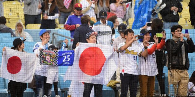 LOS ANGELES, CA - MARCH 21: Fans of team Japan take photos during warm ups before team Japan takes on team United States during Game 2 of the Championship Round of the 2017 World Baseball Classic at Dodger Stadium on March 21, 2017 in Los Angeles, California. (Photo by Harry How/Getty Images)