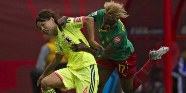 Japan defender Saki Kumagai (L) and Cameroon forward Gaelle Enganamouit fight for the ball during a Group C football match between Japan and Cameroon at BC Place Stadium in Vancouver British Columbia during the FIFA Women's World Cup Canada 2015 on June 12, 2015. AFP PHOTO/ANDY CLARK (Photo credit should read ANDY CLARK/AFP/Getty Images)