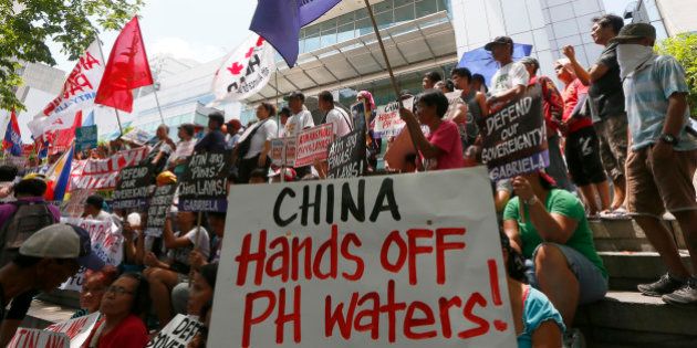 Protesters display placards during a rally outside of the Chinese Consulate hours before the Hague-based UN international arbitration tribunal is to announce its ruling on South China Sea Tuesday, July 12, 2016, in Makati city east of Manila, Philippines. The protesters are urging China to respect the Philippines' rights over its exclusive economic zone and extended continental shelf as mandated by the UN Convention of the Law of the Sea or UNCLOS. (AP Photo/Bullit Marquez)