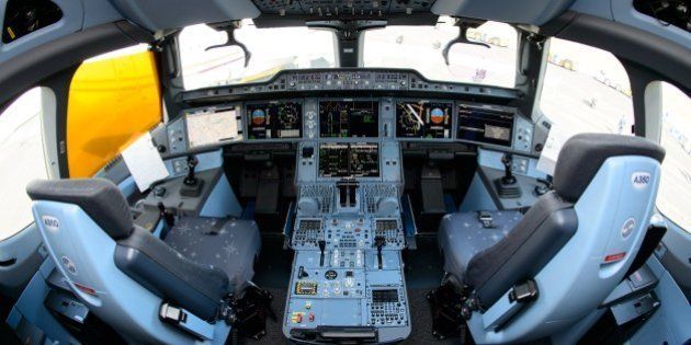 The interior view of the flight deck, or cockpit, of an Airbus A350XWB test plane is pictured at the Farnborough Air Show in Hampshire, southern England, on July 16, 2014. European aircraft maker Airbus won orders for its passenger planes from leasing companies worth about $25 billion at the Farnborough airshow on Tuesday, far outpacing its US rival Boeing. AFP PHOTO/Leon Neal (Photo credit should read LEON NEAL/AFP/Getty Images)