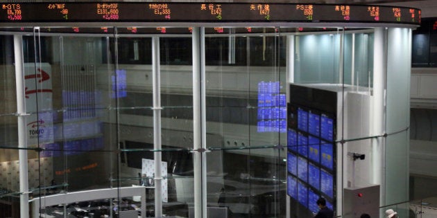 Visitors look at the trading floor of Japan Exchange Group Inc.'s Tokyo Stock Exchange in Tokyo, Japan, on Tuesday, April 30, 2013. Japan Exchange Group Inc. forecast full-year profit that was almost half of analyst estimates in its first annual earnings report after the merger of the Tokyo Stock Exchange Group Inc. and Osaka Securities Exchange Co. Photographer: Tomohiro Ohsumi/Bloomberg via Getty Images