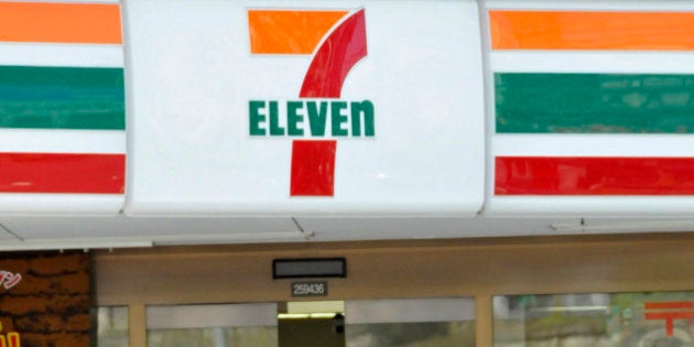 Pedestrians walk past a 7-Eleven convenience store in Tokyo on April 8, 2010. Seven & i Holdings, which operates supermarkets, department stores and 7-Eleven convenience stores in Japan and the United States, said annual net profit fell 51.4 percent year-on-year to 44.9 billion yen (481 million USD). AFP PHOTO / Yoshikazu TSUNO (Photo credit should read YOSHIKAZU TSUNO/AFP/Getty Images)