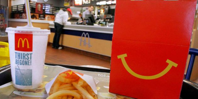 In this Jan. 20, 2012 photo, the McDonald's logo and a Happy Meal box with french fries and a drink are posed at McDonald's, in Springfield, Ill. McDonaldâs Corp. saw net income jump by 11 percent in the fourth quarter, as the fast-food giant continued to attract budget-conscious customers with low prices. (AP Photo/Seth Perlman)
