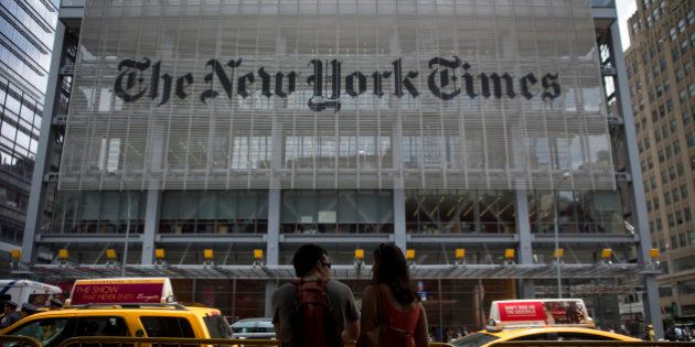 Pedestrians pass in front of The New York Times Co. offices in New York, U.S., on Wednesday, July 31, 2013. The New York Times Co. is scheduled to release earnings data on Aug. 1. Photographer: Scott Eells/Bloomberg via Getty Images