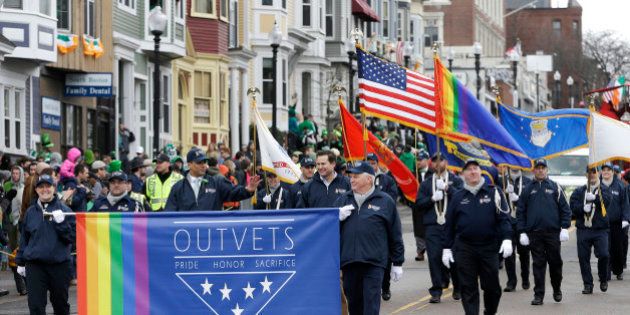 Members of OutVets, a group of gay military veterans, hold a banner and flags as they march in the St. Patrick's Day parade, Sunday, March 15, 2015, in Boston's South Boston neighborhood. Until now, gay rights groups have been barred by the South Boston Allied War Veterans Council from marching in the parade, which draws as many as a million spectators each year. (AP Photo/Steven Senne)