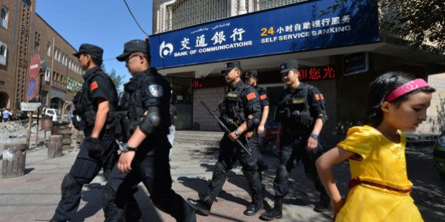 Chinese armed police patrol the streets of the Muslim Uighur quarter in Urumqi after a series of recent terrorist attacks hit Xinjiang Province on June 29, 2013. China's state-run media on June 29 blamed around 100 people it branded as 'terrorists' for sparking 'riots' in the ethnically-divided region of Xinjiang, where clashes killed 35 days earlier. AFP PHOTO / Mark RALSTON (Photo credit should read MARK RALSTON/AFP/Getty Images)