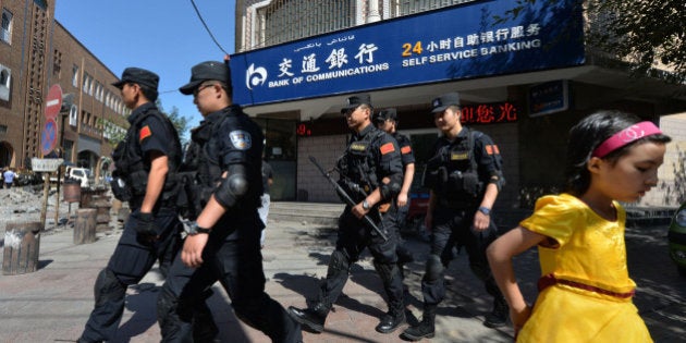 Chinese armed police patrol the streets of the Muslim Uighur quarter in Urumqi after a series of recent terrorist attacks hit Xinjiang Province on June 29, 2013. China's state-run media on June 29 blamed around 100 people it branded as 'terrorists' for sparking 'riots' in the ethnically-divided region of Xinjiang, where clashes killed 35 days earlier. AFP PHOTO / Mark RALSTON (Photo credit should read MARK RALSTON/AFP/Getty Images)