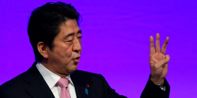 Shinzo Abe, Japan's prime minister and president of the Liberal Democratic Party (LDP), gestures as he speaks during the Liberal Democratic Party's (LDP) annual convention in Tokyo, Japan, on Sunday, Jan. 19, 2014. Abe will raise the consumption tax in April to 8 percent from 5 percent to help contain the nations swelling public debt. Photographer: Kiyoshi Ota/Bloomberg via Getty Images