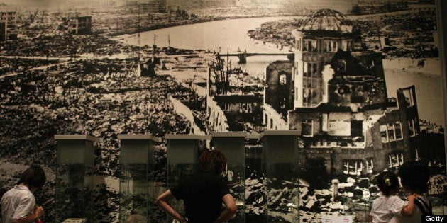 HIROSHIMA, JAPAN - JULY 27: Visitors look at a picture, showing the aftermath of the atomic bomb attack, at the museum ahead of the 60th anniversary of the dropping of the first atomic bomb at the Hiroshima Peace Memorial Park on July 27, 2005 in Hiroshima. Japan. Hiroshima will mark the 60th anniversary on August 6. (Photo by Junko Kimura/Getty Images)