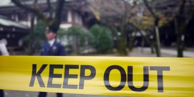 Police officers stand guard near the explosion site at the Yasukuni shrine in Tokyo on November 23, 2015. No one injured in the explosion as firefighters find the ceiling and wall of the public bathroom of the shrine burned. AFP PHOTO / TOSHIFUMI KITAMURA (Photo credit should read TOSHIFUMI KITAMURA/AFP/Getty Images)