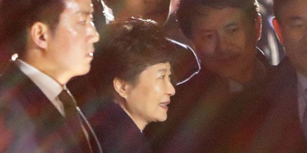 SEOUL, SOUTH KOREA - MARCH 12: Ousted South Korea President Park Geun-hye (C) smiles as she is greeted by supporters after arrival at her own home on March 12, 2017 in Seoul, South Korea. Park left the presidential palace, two days after the country's Constitutional Court removed her from office over a massive corruption scandal. (Photo by Chung Sung-Jun/Getty Images)