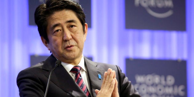 Shinzo Abe, Japan's prime minister, gestures during a session on the opening day of the World Economic Forum (WEF) in Davos, Switzerland, on Wednesday, Jan. 22, 2014. World leaders, influential executives, bankers and policy makers attend the 44th annual meeting of the World Economic Forum in Davos, the five day event runs from Jan. 22-25. Photographer: Jason Alden/Bloomberg via Getty Images