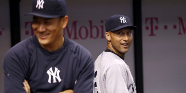 ST. PETERSBURG, FL - SEPTEMBER 16: Pitcher Masahiro Tanaka #19 of the New York Yankees and shortstop Derek Jeter #2 laugh together in the dugout before the start of a game against the Tampa Bay Rays on September 16, 2014 at Tropicana Field in St. Petersburg, Florida. (Photo by Brian Blanco/Getty Images)