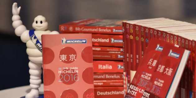 The new Michelin Guide Tokyo 2016 guidebook (L) is displayed during the publication's announcement ceremony in Tokyo on December 01, 2015. Michelin guide announced the 13 three-star restaurants, 51 two-star restaurants and 153 one-star resurarants being selected in the 2016 Tokyo guidebook. AFP PHOTO / KAZUHIRO NOGI / AFP / KAZUHIRO NOGI (Photo credit should read KAZUHIRO NOGI/AFP/Getty Images)