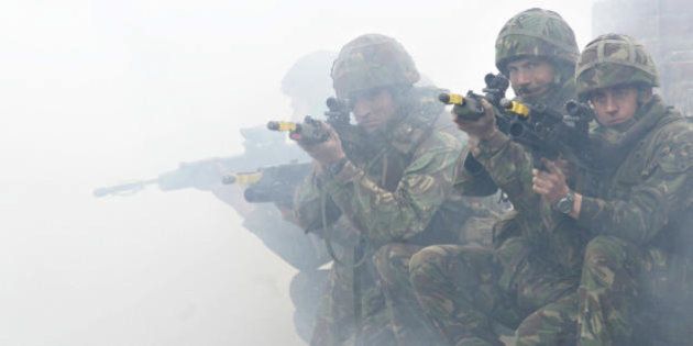 OKSBOL, DENMARK: Soldiers from the British Royal Marines Commando demonstrate city fighting techniques during the NATO Response Force exercise 16 May 2007 at Oksbol in western Jutland. (Photo credit should read CLAUS FISKER/AFP/Getty Images)