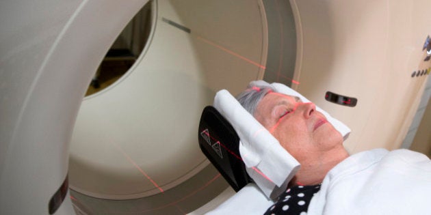 In this photo taken May 19, 2015, Judith Chase Gilbert, of Arlington, Va., is loaded into a PET scanner at Georgetown University Hospital in Washington. Gilbert shows no signs of memory problems but volunteered for a new kind of scan as part of a study peeking into healthy brains to check for clues about Alzheimer's disease. (AP Photo/Evan Vucci)