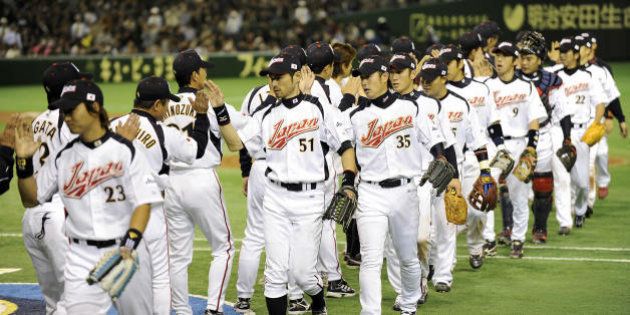Japan's national team congratulate each other after their 4-0 win against China in the World Baseball Classic first round at Tokyo Dome on March 5, 2009. The top two teams will advance to the second round in the United States from Pool A featuring Japan, Olympic champion South Korea, Taiwan and China on March 5-9. AFP PHOTO/Kazuhiro NOGI (Photo credit should read KAZUHIRO NOGI/AFP/Getty Images)