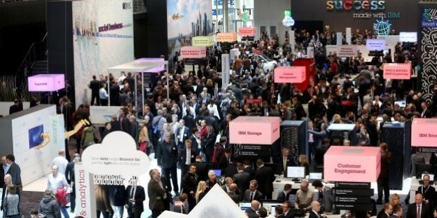 HANOVER, GERMANY - MARCH 16: Visitors walk around the International Business Machines (IBM) Company's stand at the CeBIT tech show in Hanover, Germany, on March 16, 2015. (Photo by Mehmet Kaman/Anadolu Agency/Getty Images)