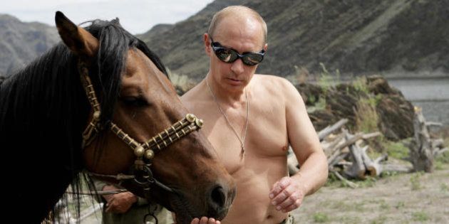 Russian Prime Minister Vladimir Putin is pictured with a horse during his vacation outside the town of Kyzyl in Southern Siberia on August 3, 2009. AFP PHOTO / RIA-NOVOSTI / ALEXEY DRUZHININ (Photo credit should read ALEXEY DRUZHININ/AFP/Getty Images)