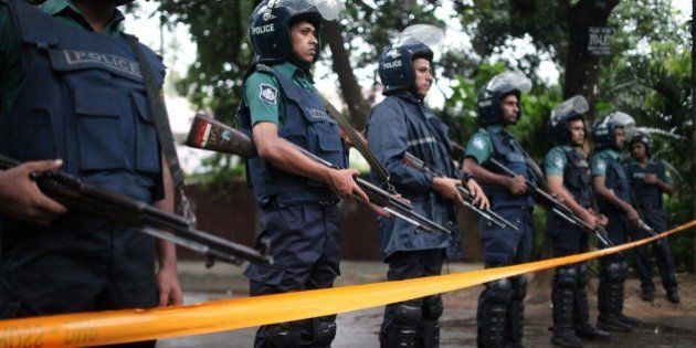 DHAKA, BANGLADESH - JULY 02 : Bangladeshi police stand guard outside the Holey Artisan Bakery cafe, currently under a hostage siege by armed gunmen in Dhaka, Bangladesh on July 02, 2016. Multiple foreigners are being held hostage by eight or nine gunmen at O'kitchen restaurant, in the same building as the the Holey Artisan Bakery cafe - a location popular with expatriates and diplomats. A gun battle between the attackers and police wounded three people, including two officers. Police and security forces have sealed off the area in the city's Gulshan district and are trying to negotiate a hostage release. (Photo by zakir hossain chowdhury/Anadolu Agency/Getty Images)