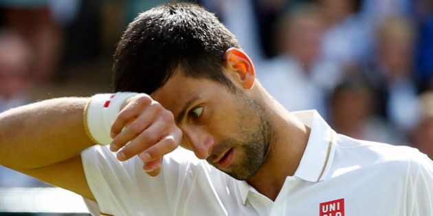 Novak Djokovic of Serbia wipes his face during his men's singles match against Sam Querrey of the U.S on day six of the Wimbledon Tennis Championships in London, Saturday, July 2, 2016. (AP Photo/Alastair Grant)