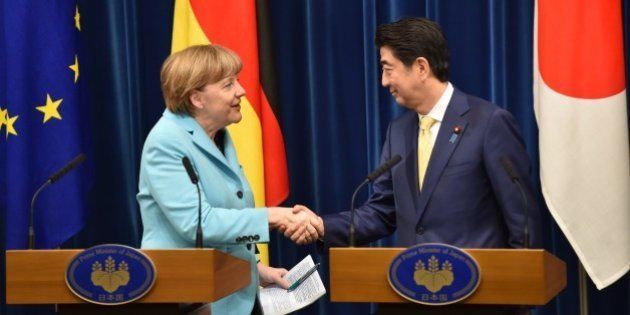 German Chancellor Angela Merkel (L) and Japanese Prime Minister Shinzo Abe (R) shake hands after their joint press conference at the latter's official residence in Tokyo on March 9, 2015. Merkel is on a two-day visit to Japan. AFP PHOTO / KAZUHIRO NOGI (Photo credit should read KAZUHIRO NOGI/AFP/Getty Images)