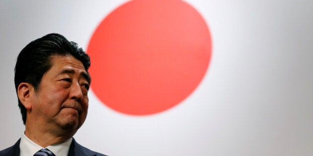 Japan's Prime Minister Shinzo Abe stands in front of Japan's national flag after his ruling Liberal Democratic Party's (LDP) annual party convention in Tokyo, Japan, March 5, 2017. REUTERS/Toru Hanai