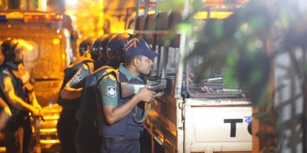 DHAKA, BANGLADESH - JULY 02 : Bangladeshi police stand guard outside the Holey Artisan Bakery cafe, currently under a hostage siege by armed gunmen in Dhaka, Bangladesh on July 02, 2016. Multiple foreigners are being held hostage by eight or nine gunmen at O'kitchen restaurant, in the same building as the the Holey Artisan Bakery cafe - a location popular with expatriates and diplomats. A gun battle between the attackers and police wounded three people, including two officers. Police and security forces have sealed off the area in the city's Gulshan district and are trying to negotiate a hostage release. (Photo by zakir hossain chowdhury/Anadolu Agency/Getty Images)