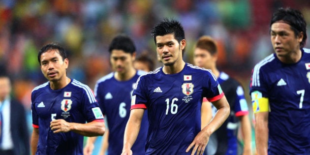 RECIFE, BRAZIL - JUNE 14: Yuto Nagatomo (L) and Hotaru Yamaguchi of Japan walk off the field with teammates after being defeated by the Ivory Coast 2-1 during the 2014 FIFA World Cup Brazil Group C match between the Ivory Coast and Japan at Arena Pernambuco on June 14, 2014 in Recife, Brazil. (Photo by Jamie Squire/Getty Images)