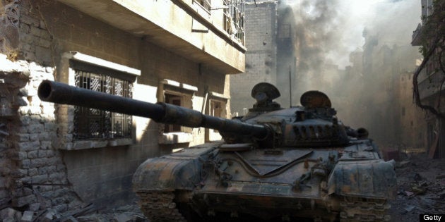 A government forces tank is seen in the Khalidiyah neighbourhood of Syria's central city of Homs on July 28, 2013. Government forces bolstered by Lebanese Shiite militiamen were poised to retake the largest rebel-held district of Syria's third city Homs, a watchdog and state media said. AFP PHOTO/STR (Photo credit should read STR/AFP/Getty Images)