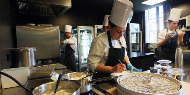 Employees of 'El Celler de Can Roca' work in the restaurant's kitchen in Girona on April 30, 2013. Spain's El Celler de Can Roca seized the title of the world's best restaurant from Denmark's Noma on April 29, one month after dozens of people came down with a bout of food poisoning from the Copenhagen eatery. The restaurant in Girona, run by three brothers and known for its dishes based on perfumes, had spent two years as runner-up on the World's 50 Best Restaurants list compiled for a 12th year by more than 900 international experts for Britain's Restaurant magazine. AFP PHOTO / QUIQUE GARCIA (Photo credit should read QUIQUE GARCIA/AFP/Getty Images)