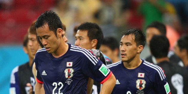 RECIFE, BRAZIL - JUNE 14: Maya Yoshida (L) and Shinji Okazaki of Japan walk off the field after being defeated by the Ivory Coast 2-1 during the 2014 FIFA World Cup Brazil Group C match between the Ivory Coast and Japan at Arena Pernambuco on June 14, 2014 in Recife, Brazil. (Photo by Clive Rose/Getty Images)