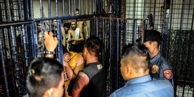 MANILA, PHILIPPINES - JUNE 20: Drug suspects are led into a crowded jail cell on June 20, 2016 in Manila, Philippines. The president-elect of the Philippines, Rodrigo Duterte, declared a war on crime and drugs after sweeping an election on May 9 and has been living up to his nickname, 'the punisher'. Philippine police have been conducting night raids almost on a daily basis and revived a curfew for minors that had not been enforced for years, rounding up minors drinking on the streets. Based on local reports, there has been at least 59 drug-related deaths since the election and hundreds of drug suspects arrested over one month as Duterte reassured police on his full support if they killed criminals who resisted with violence. The raids have caused concern for Catholic church officials and human rights advocates as Duterte officially takes his oath as the 16th president of the Republic of the Philippines on June 30. (Photo by Dondi Tawatao/Getty Images)