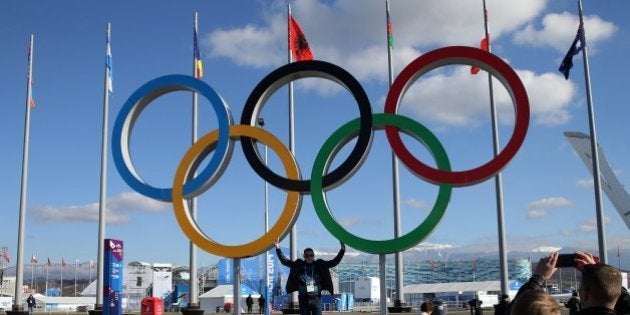 People pose with the Olympic rings inside Olympic Park at the Winter Olympics in Sochi, Russia, Thursday, Feb. 6, 2014. (Brian Cassella/Chicago Tribune/MCT via Getty Images)