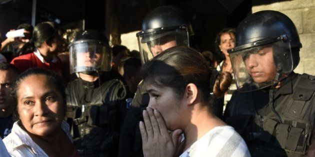 Relatives gather outside the children's shelter Virgen de la Asuncion after a fire at the facility killed at least 19 people, in San Jose Pinula, about 10 kilometres east of Guatemala City, on March 8, 2017.At least 19 people died in a fire at a children's shelter in Guatemala, a spokesman for the local fire service said. It was not immediately known how many of the bodies were those of children. The center, supervised by state social welfare authorities, hosts minors who are victims of family mistreatment. The facility has been the target of multiple complaints alleging abuse, and several children have run away. / AFP PHOTO / JOHAN ORDONEZ (Photo credit should read JOHAN ORDONEZ/AFP/Getty Images)