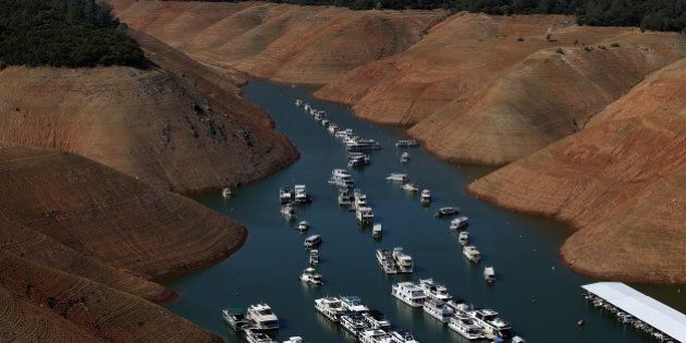 OROVILLE, CA - AUGUST 19: House boats are dwarfed by the steep banks of Lake Oroville that used to be under water on August 19, 2014 in Oroville, California. As the severe drought in California continues for a third straight year, water levels in the State's lakes and reservoirs is reaching historic lows. Lake Oroville is currently at 32 percent of its total 3,537,577 acre feet. (Photo by Justin Sullivan/Getty Images)