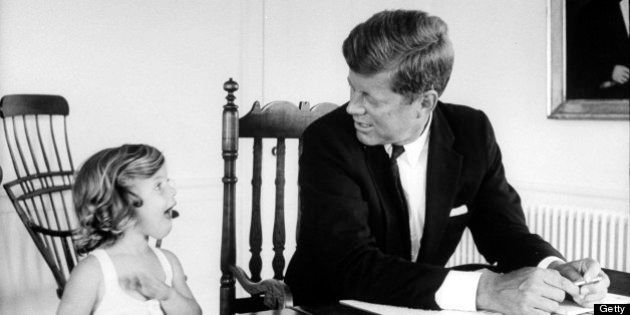 Sen. John Kennedy chatting w. his young daughter Caroline as he goes over some papers on table at his Georgetown home. (Photo by Alfred Eisenstaedt//Time Life Pictures/Getty Images)