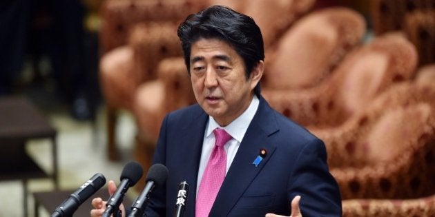 Japanese Prime Minister Shinzo Abe answers questions during the Lower House's ad hoc committee session to expand the scope of Japan's self defence force overseas operations at the National Diet in Tokyo on May 27, 2015. Japanese parliament began deliberations on the bills bolstering the role and scope of the military, as the pacifist country redefines its position in the increasingly roiled Asia-Pacific region. AFP PHOTO / Yoshikazu TSUNO (Photo credit should read YOSHIKAZU TSUNO/AFP/Getty Images)