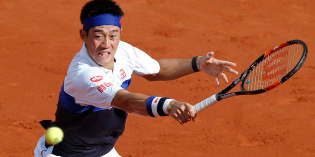Japan's Kei Nishikori returns the ball to France's Jo-Wilfried Tsonga during their quarterfinal match of the French Open tennis tournament at the Roland Garros stadium, Tuesday, June 2, 2015 in Paris, France. (AP Photo/Michel Euler)