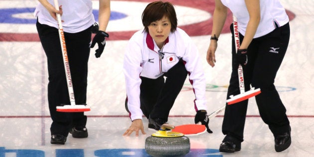 SOCHI, RUSSIA - FEBRUARY 11: Michiko Tomabechi and Chinami Yoshida of Japan of Japan sweep the ice as...
