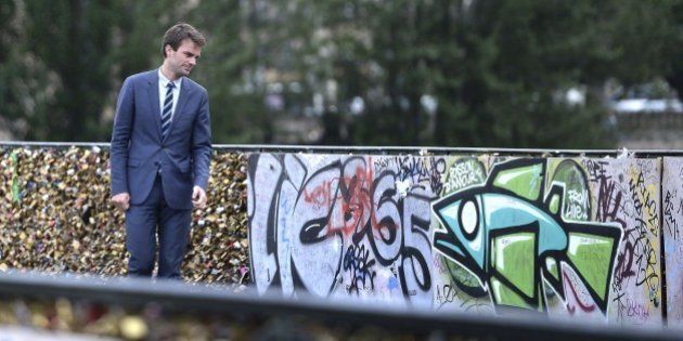 Paris Deputy Mayor Bruno Julliard stands on the Pont des Arts during the removal of love padlocks attached on the railings of the bridge on June 1, 2015 in Paris. Started by tourists in Paris in 2008, the love locks ritual, which also spread in the early 2000s to cities including New York, Seoul and London, has resulted in the transformation of several bridges : every inch of their railings is now covered with clunky brass padlocks. AFP PHOTO / STEPHANE DE SAKUTIN (Photo credit should read STEPHANE DE SAKUTIN/AFP/Getty Images)