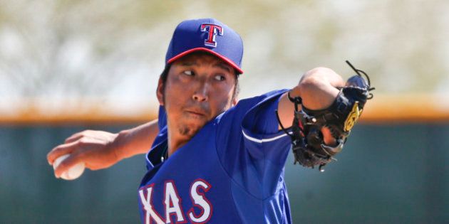 Texas Rangers pitcher Kyuji Fujikawa pitches in an intrasquad game prior to a spring training baseball game against the Seattle Mariners Friday, March 20, 2015, in Surprise, Ariz. (AP Photo/Lenny Ignelzi)