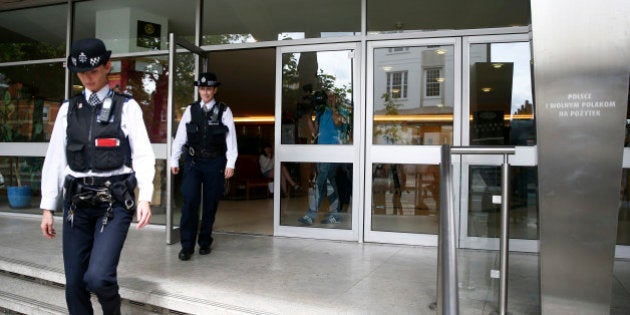 Police officers leave the Polish Social and Cultural Association after graffiti was painted on the side of the building calling on Poles to leave the United Kingdom, in Hammersmith, London, Britain June 27, 2016. REUTERS/Neil Hall